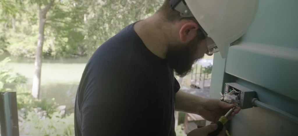 Licensed electrician installing wiring inside a Florida container home