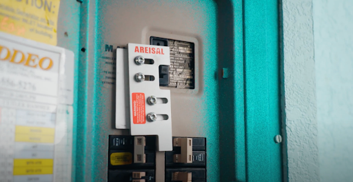 Licensed electrician installing a generator transfer switch for a Florida home