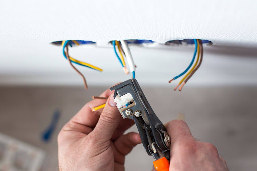 technician working on electrical panel upgrade for home addition